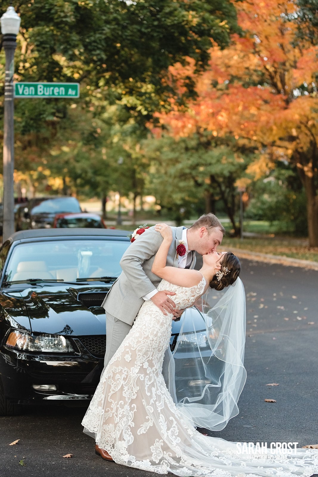 Naperville wedding couple kissing in front of Van Buren Ave.